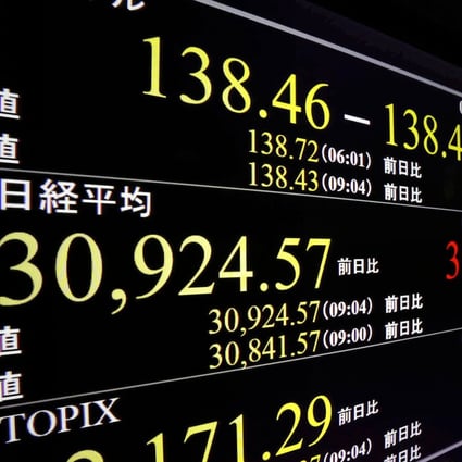 A stock monitor in Tokyo shows the Nikkei 225 topping 30,900 on the morning of May 19. The index hit a 33-year high on May 22, reaching levels not seen since the bursting of the asset-inflated bubble economy in the early 1990s. Photo: Kyodo