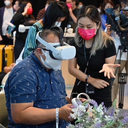 A visitor uses a virtual reality headset at the Meta booth on the first day of Fintech Week in Hong Kong on October 31, 2022. Photo: AFP