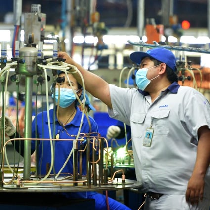 People work on a production line at a metals factory in Thailand. Photo: Xinhua