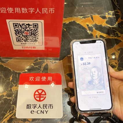 A customer makes a payment using China’s digital yuan, or e-CNY, at the Wangfujing Department Store in Beijing. Central bank digital currencies allow central banks to retain control while providing a financial system that avoids scams. Photo: Getty Images