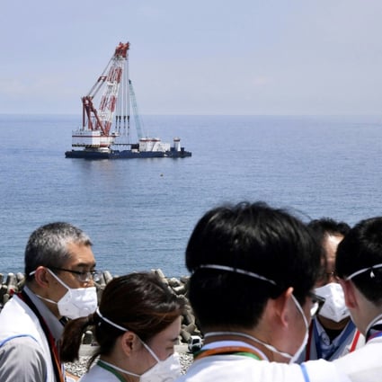 A work ship is seen offshore where the Tokyo Electric Power Company says it has installed  the last piece of an undersea tunnel to be used to release treated radioactive wastewater, during a media tour of the Fukushima Daiichi nuclear power plant in northern Japan on June 26. Photo: AP
