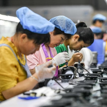 Employees work on an assembly line producing speakers at a factory in Fuyang in China’s eastern Anhui province. Photo: AFP