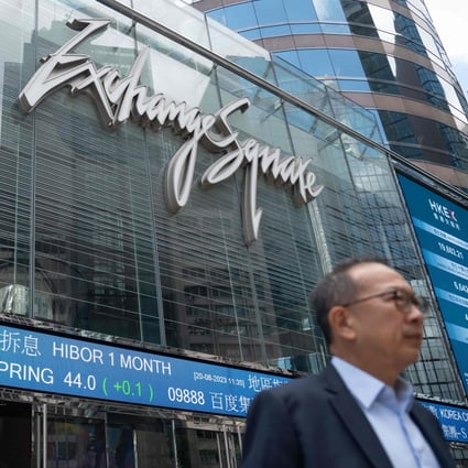 A man walks past an electronic sign showing stocks at Exchange Square in Hong Kong on June 20. Photo: AFP