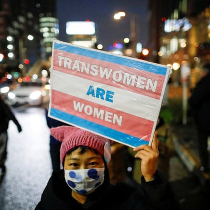 A demonstrator holds a placard during a march to call for gender equality and protest against gender discrimination in Tokyo, Japan, in March 2021. Photo: Reuters