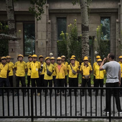 Food delivery workers of Chinese online on-demand services giant Meituan Dianping attend a morning briefing in Beijing. Photo: Agence France-Presse