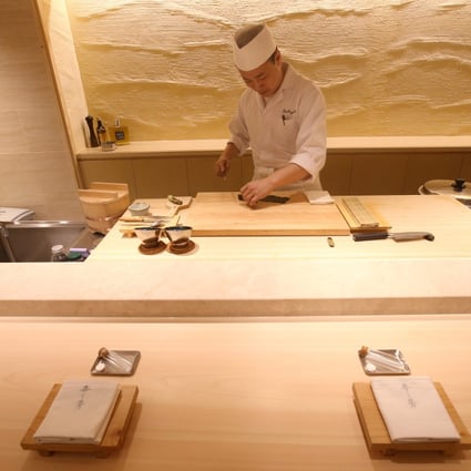 Sushiyoshi diners sit at a 200-year-old cypress wood counter.