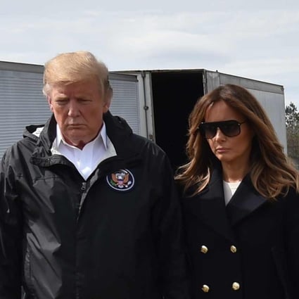 US President Donald Trump and First Lady Melania Trump stand before a row of crosses honouring 23 people who died in the storm outside Providence Baptist Church in Opelika, Alabama during a March 8 visit. Photo: AFP