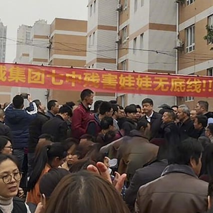 Parents gathered outside the school to protest on Wednesday. Photo: Weibo