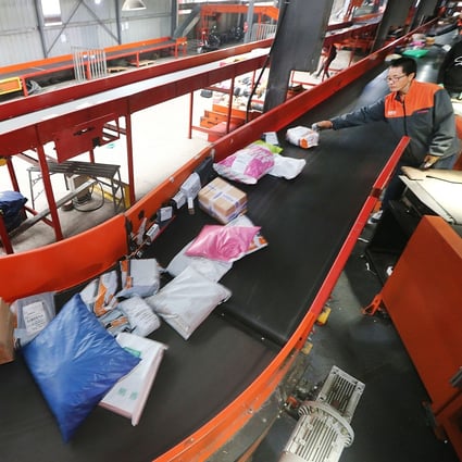 Employees work at a distribution centre of a delivery company in eastern China's Jiangsu province. The country’s major e-commerce companies are sharpening their focus on consumers in smaller cities to help boost consumption amid slowing growth. Photo: Xinhua