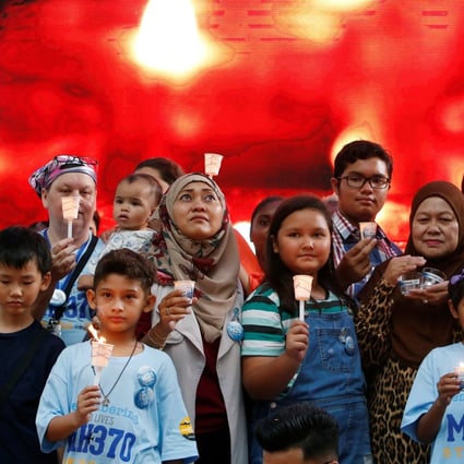 Family members hold candles during the fifth annual remembrance event for missing Malaysia Airlines flight MH370, in Kuala Lumpur, Malaysia on March 3. Photo: Reuters