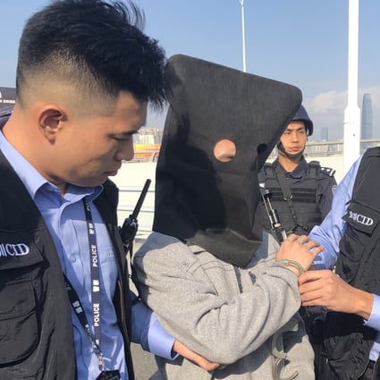 A fugitive is handed over to Hong Kong police by mainland authorities in December. Photo: Handout