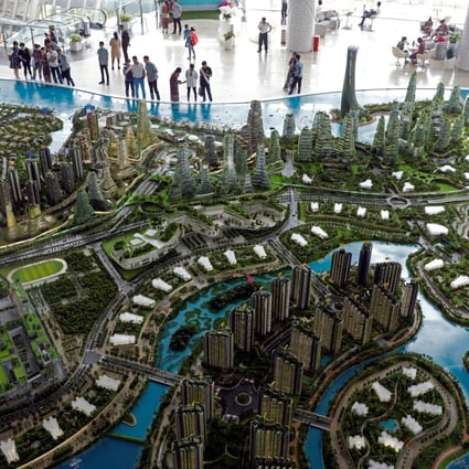 Potential buyers look at a model of Country Gardens’ Forest City project in Johor, Malaysia. Photo: Reuters
