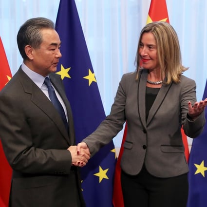 Chinese Foreign Minister Wang Yi is welcomed by EU foreign policy chief Federica Mogherini ahead of a meeting in Brussels. Photo: Reuters