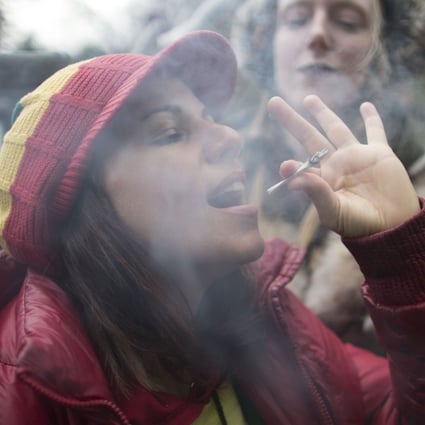 Some Canadian mothers say cannabis makes them better parents. Here a woman smokes a marijuana cigarette during a legalisation party in Toronto. Photo: AFP