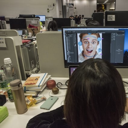 At Megvii offices in Beijing, a designer prepares marketing material for a facial-recognition product. The company's marketing manager has said Megvii's Face program has helped police make thousands of arrests. Photo: The Washington Post
