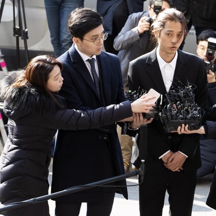South Korean singer Jung Joon-young (centre) talks to reporters on March 14 after arriving at the Metropolitan Police Agency in Seoul, South Korea. Photo: EPA-EFE/Yonhap