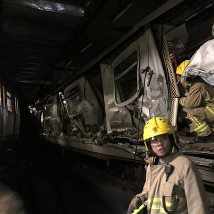 Firefighters survey the tangled wreckage of two trains that collided on the Tsuen Wan line in Hong Kong. Photo: Handout