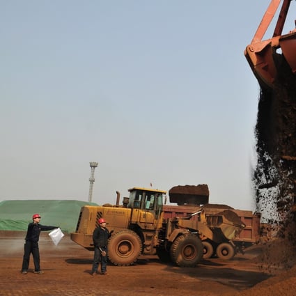 Officials of the local Entry-Exit Inspection and Quarantine Bureau (CIQ) prepare to take samples of iron ore imported from India in the port in Rizhao in east China's Shandong province in 2012. Photo: EPA