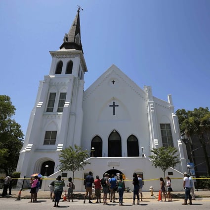 People gather outside Emanuel African Methodist Episcopal Church in Charleston, in the US state of South Carolina, a day after a mass shooting left nine dead in June 2015. Photo: Reuters