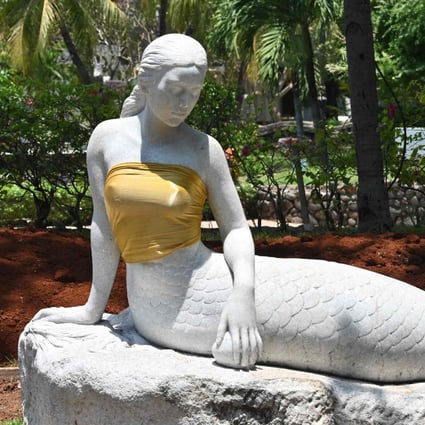 A pair of bare-breasted mermaid statues have been given some family values treatment at an Indonesian theme park. Photo: AFP