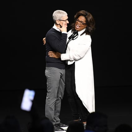Tim Cook, chief executive officer of Apple Inc, and Oprah Winfrey laugh on stage at the Steve Jobs Theatre in Cupertino, California, on Monday. Photo: Bloomberg