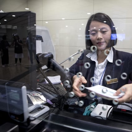 A ticket counter at the West Kowloon station of the Guangzhou-Shenzhen-Hong Kong Express Rail Link. Too few counters to deal with passengers transferring trains in mainland China can be a recipe for impatient customers and tired staff. Photo: Bloomberg