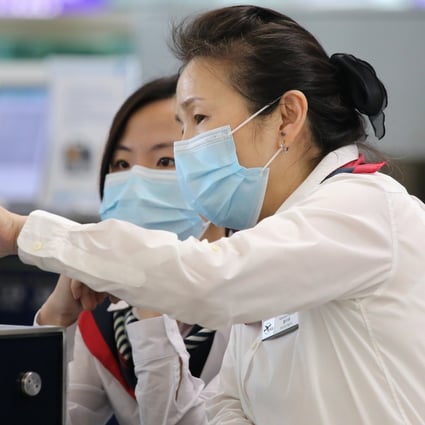 Staff at Hong Kong International Airport wear face masks during the measles outbreak. Photo: Dickson Lee