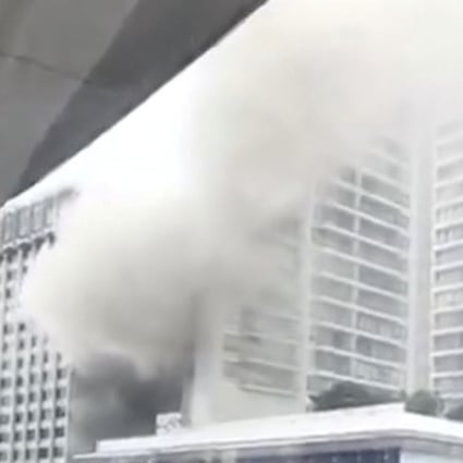 Smoke billows along a street after a fire broke out at the Grand Hyatt Hotel in Orchard Road. Photo: Reuters