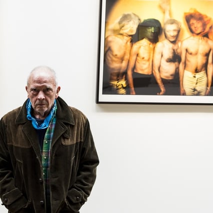English fashion and portrait photographer David Bailey poses in front of two of his images of British rock band The Rolling Stones which feature in a large-format Taschen book of his work. Photo: Jay Clendenin/Los Angeles Times/TNS)