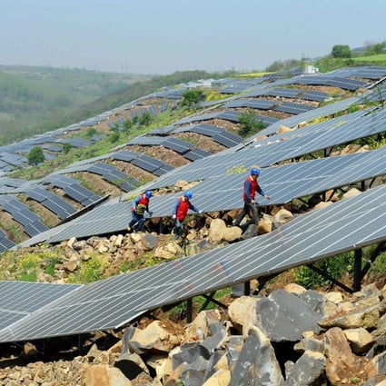 Workers check solar photovoltaic panels on a hillside in Anhui province, China. Solar panels are a key player in the fast-growing renewable energy sector, which also includes water- and wind-generated electricity. Photo: AFP