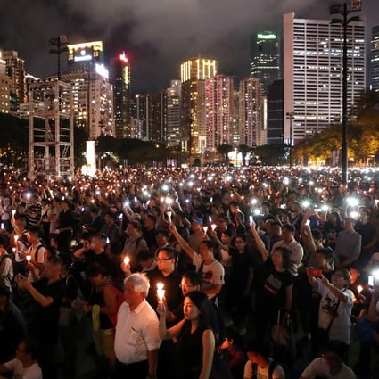 People holding candles during the June 4 candlelight vigil at Victoria Park last year. Photo: K.Y. Cheng