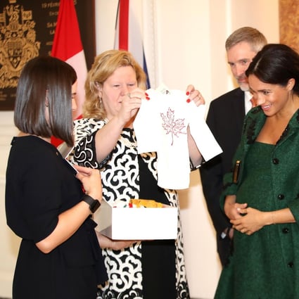 Meghan, Duchess of Sussex (second right) and Britain’s Prince Harry, Duke of Sussex (right), reacting as they are presented with baby gifts by the Canadian High Commissioner to the United Kingdom, Janice Charette (second left), at Canada House in the UK. Photo: AFP