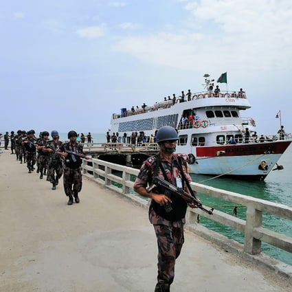 Border Guards Bangladesh (BGB) paramilitary personnel disembark on Saint Martin’s island in the Bay of Bengal on Sunday. This is the first time they have been deployed to an island near its southern border with Myanmar in 20 years, officials said. Photo: STR via AFP
