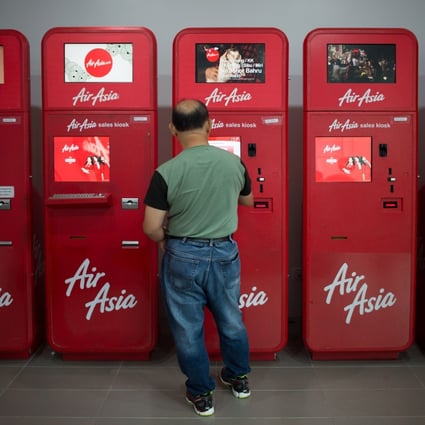 AirAsia was the first carrier in Southeast Asia to deploy wide-scale self check-in kiosks. This photo was taken on January 10, 2015, at the low-cost carrier terminal in Kuala Lumpur’s international airport. Photo: AFP