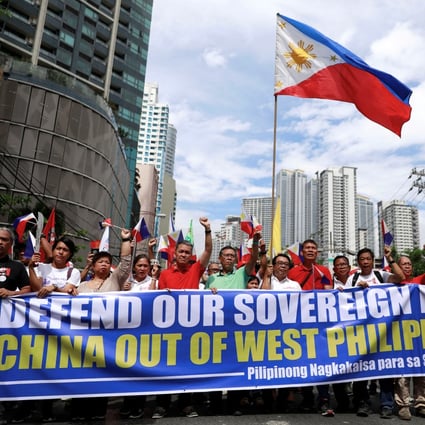 Activists and opposition leaders protest over the presence of Chinese vessels in the South China Sea at the Chinese embassy in Makati City, Philippines. Photo: Reuters