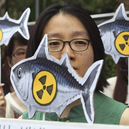 Environmentalists stage a rally denouncing imported agricultural and marine products from Japan. Photo: AP