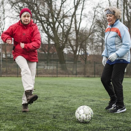 A member of the Momseholdet, or grannies soccer team in Frederikssund, Denmark, kicks the ball while her teammates look on during a Football Fitness training session. The Danish concept uses training in the game’s skills to promote exercise and limit lifestyle diseases. Photo: Gregers Tycho