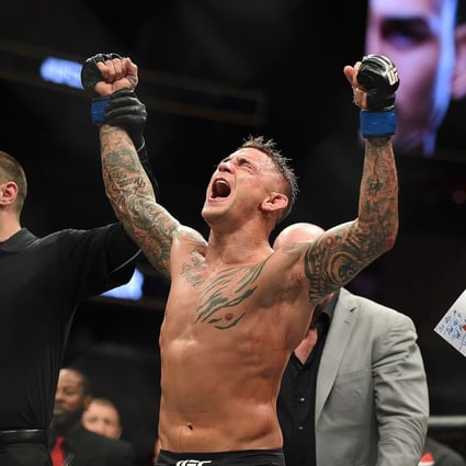 Dustin Poirier celebrates after receiving the title belt from UFC president Dana White. Photo: AFP