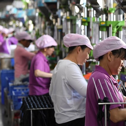 Women work on a data cable production line at a factory in Xinyu, Jiangxi province, China April 8, 2019. Photo: Reuters