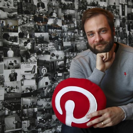 Evan Sharp, Pinterest co-founder and chief product officer, poses for a photo in his office beside a wall of pinned photos he has taken at Pinterest headquarters in San Francisco. Photo: AP
