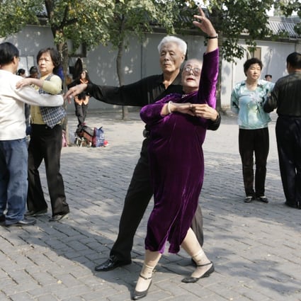 Elderly people dance during a morning exercise session at the Temple of Heaven park in Beijing. Photo: Reuters