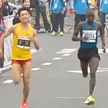 Wu Xiangdong sprints to the finish to become China’s top finisher at the Shanghai international half-marathon. He was later interviewed on TV. Photo: Sina.com
