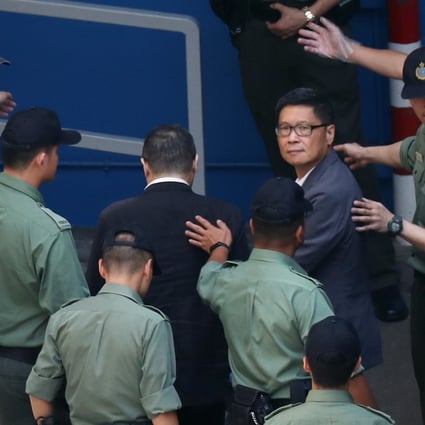 Occupy leaders, Benny Tai (left) and Chan Kin-man (right) arrive at the Lai Chi Kok Reception Centre, where they spent their first night behind bars. Photo: Robert Ng