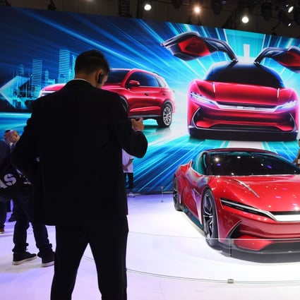 Visitors to the Shanghai Auto Show photograph the BYD E-SEED GT electric concept caron April 17, 2019. Photo: AFP