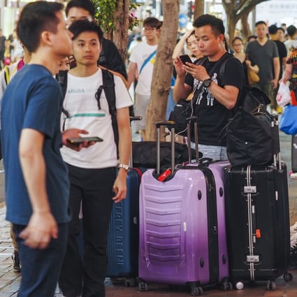 Tourists outside Times Square in Causeway Bay. Photo: Martin Chan