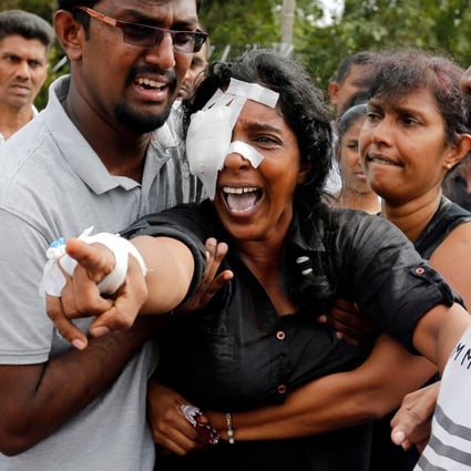 Kumari Fernando, who lost her husband and two children, during a mass burial for victims. Photo: Reuters