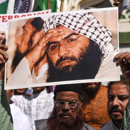 Indian Muslims holding a photo of Masood Azhar shout slogans against Pakistan after a terror attack in Kashmir. Photo: AFP