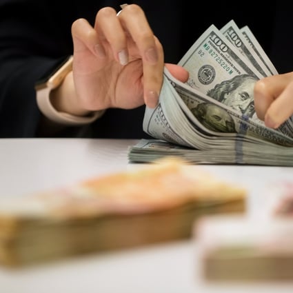 The change means a withdrawal of US$3,000 or more in a single transaction requires proof of need, such as an airline ticket for overseas travel, or a health certificate. Photo: Bloomberg