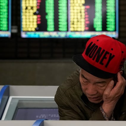 An investor at a brokerage in Shanghai on May 6, 2019. Contrary to global conventions, China’s stock markets represent losses and declines in green, and uses red to represent gains and advances. Photo: REUTERS
