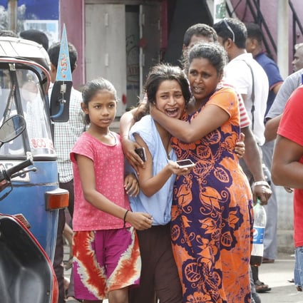 People run to safety after a van is found to contain a suspected explosive device, near St Anthony’s Church in Colombo on April 22. The previous day, nearly 300 people were killed and over 500 injured in a series of blasts in the city during Easter Sunday service. Photo: EPA-EFE